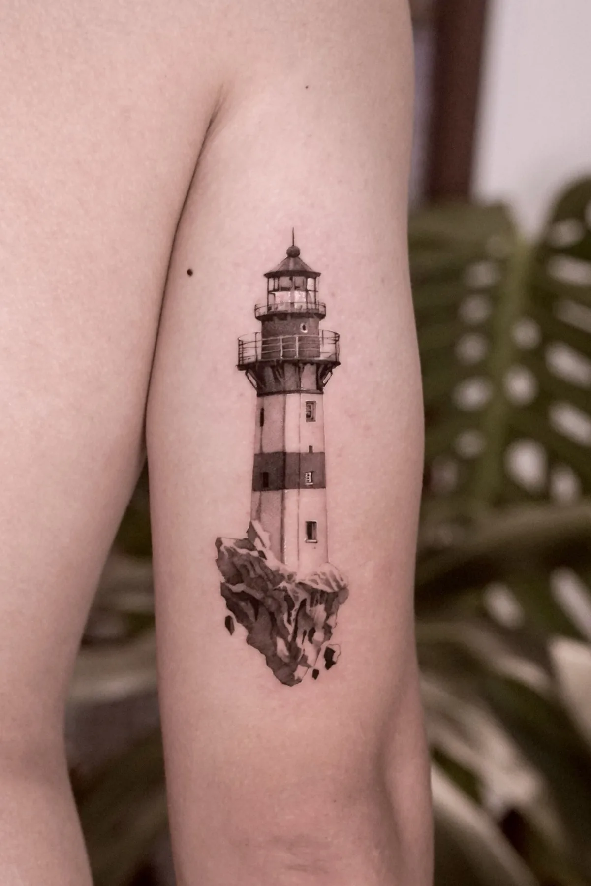 Lighthouse tattoo on the arm by Moussa in Shanghai