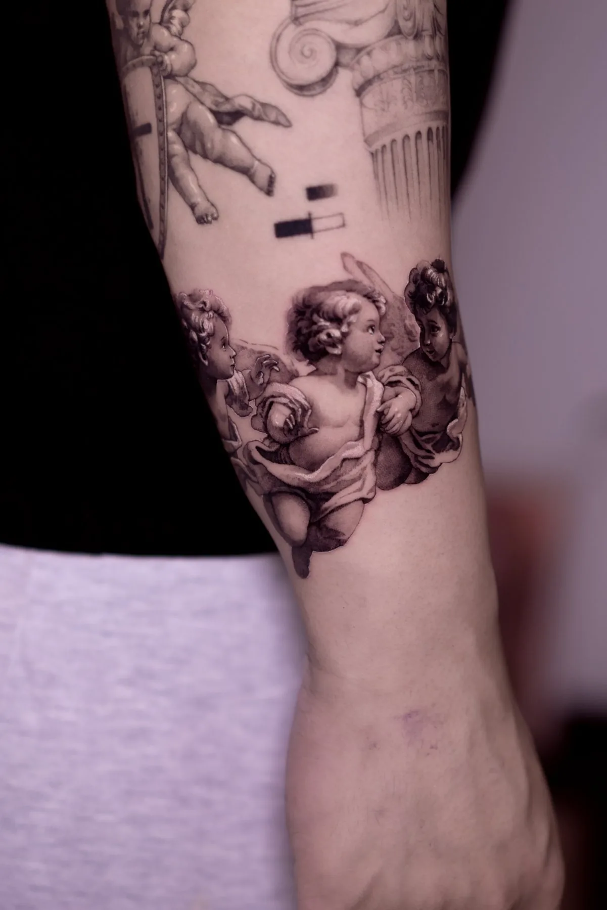 Three Angels tattoo on the arm by Moussa in Shanghai